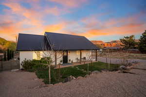 Back of house featuring metal roof, fence, a patio, stucco siding, and a mountain view