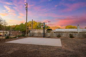 View of basketball court featuring fence and basketball court