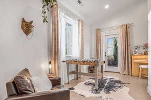 Sitting room featuring recessed lighting, lofted ceiling, visible vents, and light speckled floor