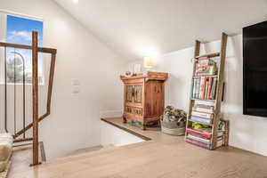 Interior space with vaulted ceiling and wood finished floors