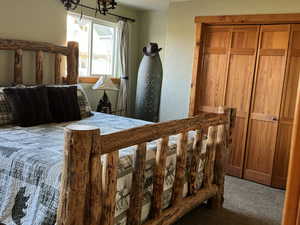 Carpeted bedroom with a chandelier