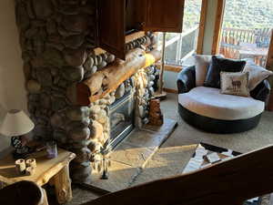 Living room featuring a fireplace and carpet