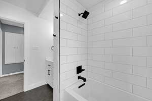 Full bath with tile patterned floors, baseboards, vanity, and bathing tub / shower combination