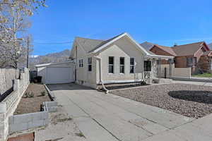 Ranch-style home with concrete driveway, stucco siding, a mountain view, an attached garage, and fence