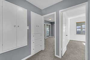 Hall with carpet floors and baseboards