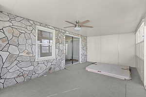 Unfurnished room with ceiling fan and carpet