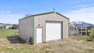 Detached garage with fence and a mountain view