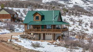 View of front of house featuring metal roof, a standing seam roof, and a garage