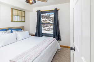Bedroom featuring baseboards and carpet