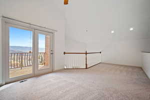 Second sleeping/office area featuring vaulted ceiling, baseboards, recessed lighting, and light colored carpet
