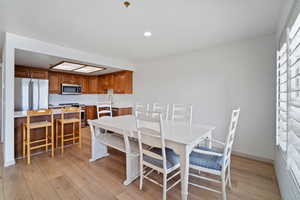 Dining space featuring recessed lighting and light wood-style flooring