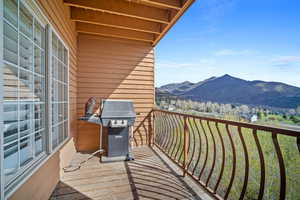 Balcony featuring grilling area and a mountain view
