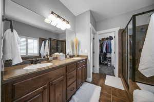 This spa style primary main level bath offers dual vanity, oversized soaking tub, separate shower and walk-in closet.