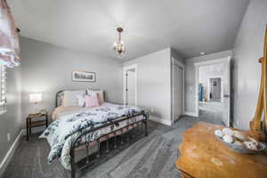 This room is like a second primary suite with an attached full bathroom plus plantation shutters, newer paint and newer carpeting.