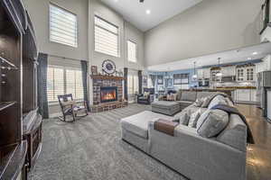 The two-story great room offers newer carpeting, several large windows, a stunning rock fireplace and direct access to the farmhouse kitchen.