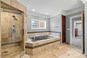 Bathroom featuring a shower stall, crown molding, a garden tub, and recessed lighting