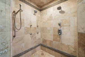 Full bath featuring tiled shower