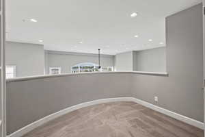 Empty room with carpet floors, baseboards, and recessed lighting