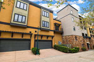 View of front of house with concrete driveway, a garage, and stucco siding