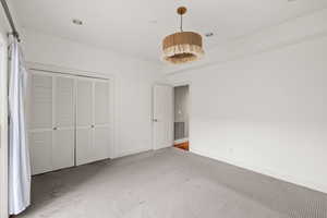 Unfurnished bedroom featuring a closet, carpet flooring, baseboards, and visible vents