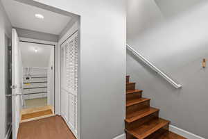 Staircase featuring wood finished floors and baseboards