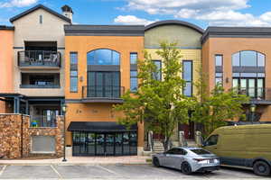 View of building exterior with uncovered parking