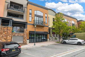 View of property featuring uncovered parking