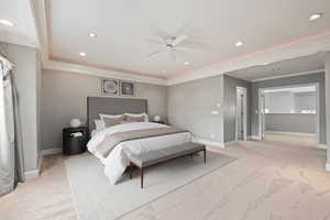 Bedroom with light colored carpet, baseboards, ornamental molding, and recessed lighting