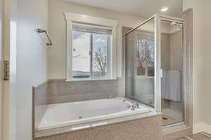 Bathroom featuring a shower and a jetted tub