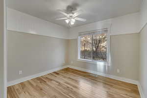 Bedroom with a ceiling fan, crown molding, and hardwood / wood-style floors