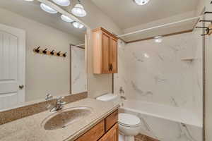 Full bath with vanity, toilet, and shower / washtub combination