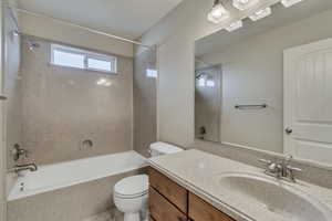 Bathroom with toilet, tub / shower combination, tile patterned flooring, and vanity