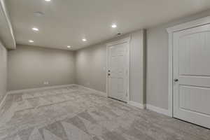 Carpeted spare room with recessed lighting