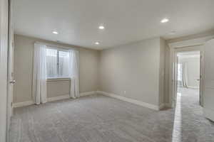 Spare room with a great amount of sunlight, carpet, and recessed lighting