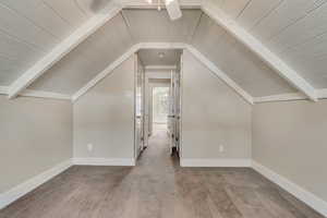 Additional living space featuring, vaulted ceiling with beams, and carpet flooring