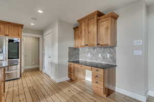 Kitchen with stainless steel fridge with ice dispenser, and built in desk