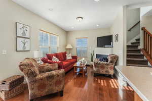 Living room featuring hardwood / wood-style floors and stairs
