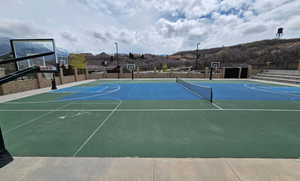 View of basketball court featuring fence and community basketball court