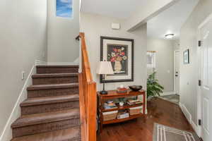 Stairway featuring hardwood / wood-style flooring and baseboards