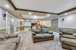 Basement family room has open plan with french doors leading to hallway