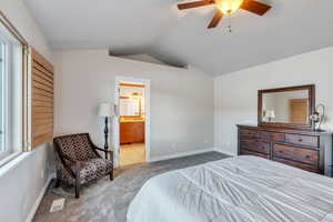 Primary suite has en suite bath and vaulted ceilings