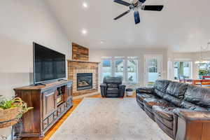Large living room has tall windows and fireplace