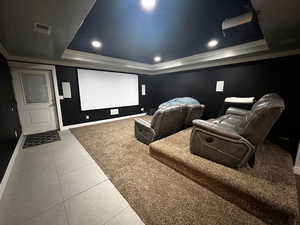 Tiled cinema featuring visible vents, baseboards, a raised ceiling, and recessed lighting
