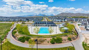 View of swimming pool with fence, a residential view, and a mountain view