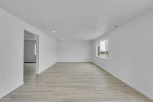 Spare room featuring light wood finished floors and recessed lighting