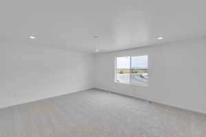 Spare room with light carpet and recessed lighting