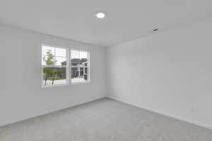 Empty room featuring carpet and baseboards