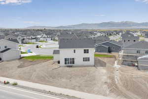 Aerial perspective of suburban area featuring a mountainous background