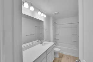 Full bathroom featuring  shower combination, light wood-type flooring, and vanity