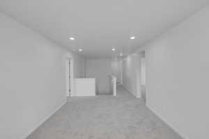 Empty room featuring light colored carpet and recessed lighting